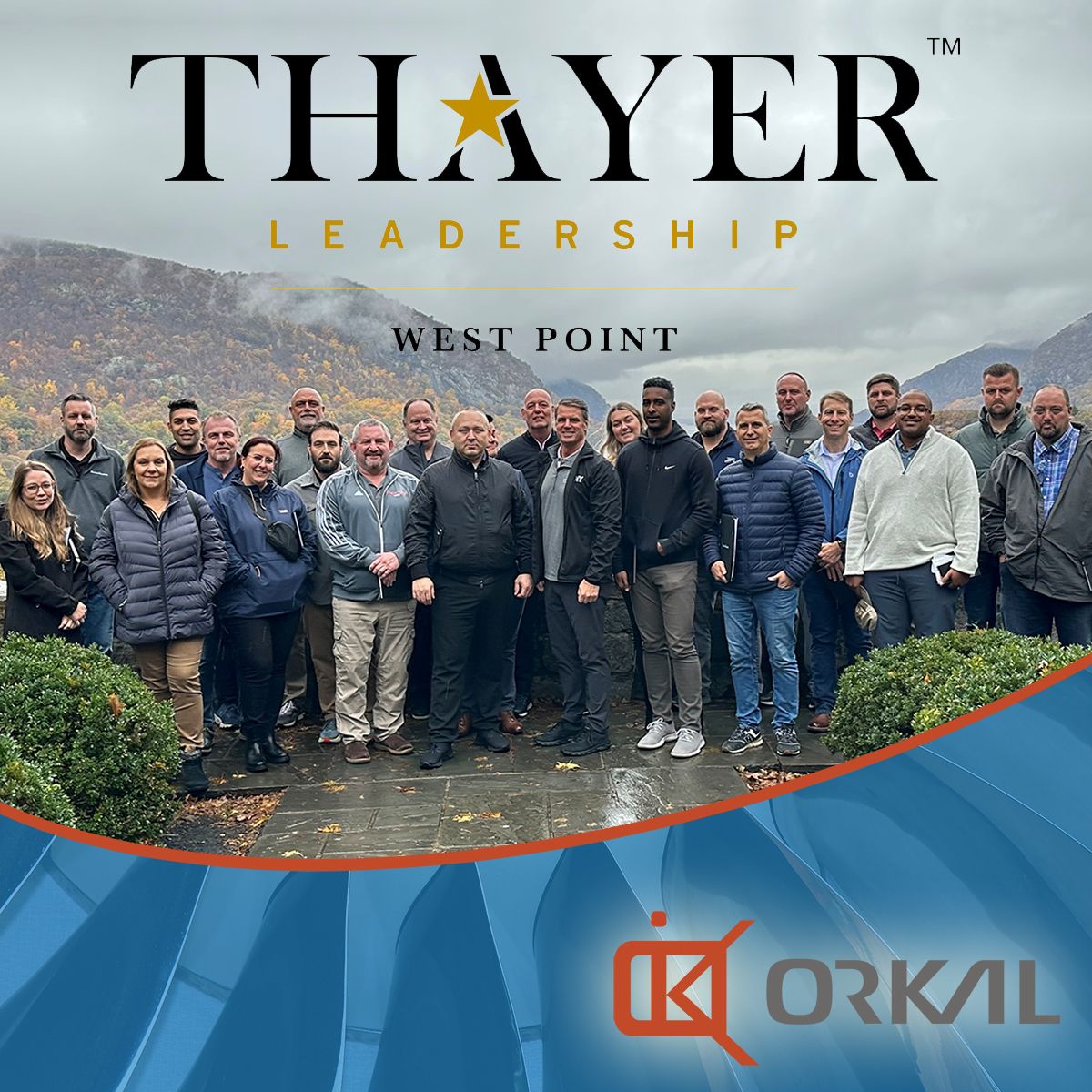 group of professionals posing for a photo at a thayer leadership training program event at west point, featuring the thayer and orkal logos.