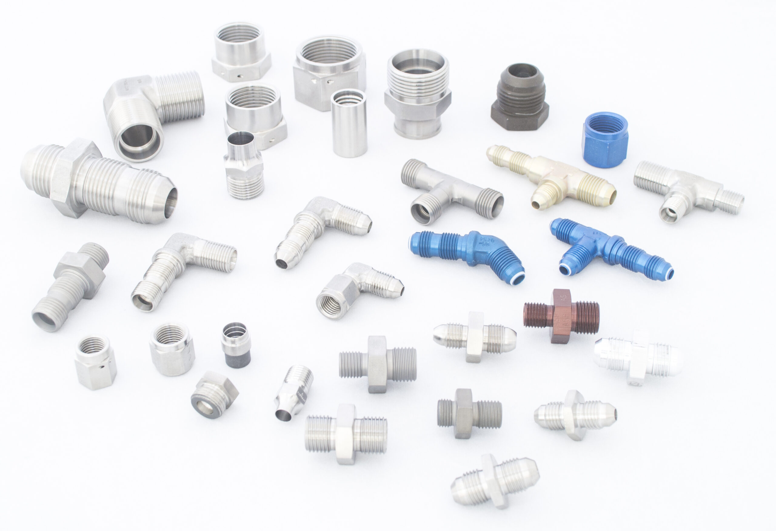 an assortment of metal fluid fittings and connectors in various sizes and shapes, displayed on a white background.