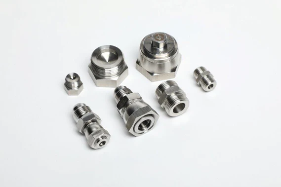 Various metal mechanical parts, including connectors and Beam Seal Linecard fittings, displayed on a white background.